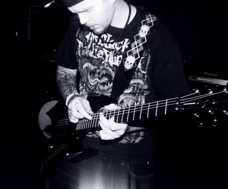 Ryan Red playing guitar on stage